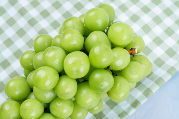 Fresh of Shine Muscat Grape with tablecloth on wooden background