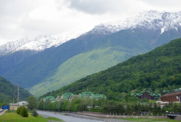 Rosa Khutor embankment, mountains and river. Krasnaya Polyana, Sochi.