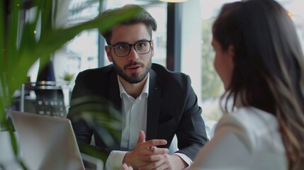 Young specialist sales explains to couple clients in office
