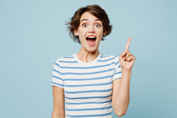 Young smart proactive woman she wears striped t-shirt casual clothes holding index finger up with great new idea isolated on plain pastel light blue cyan background studio portrait. Lifestyle concept. © ViDi Studio