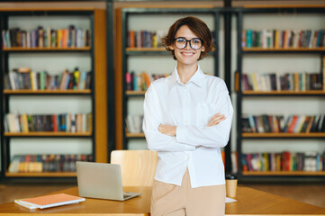 Young fun happy successful employee business woman she wear glasses white shirt casual clothes hold...