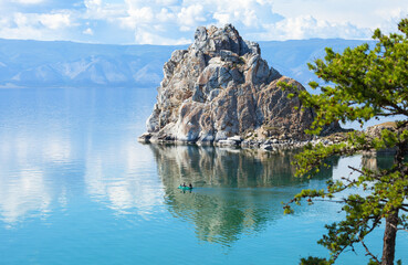 Baikal Lake. Tourists spend their summer holidays on Olkhon Island, ride rubber boat near famous...