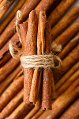 Cinnamon sticks dried tree bark spice on white table background. Selective focus.