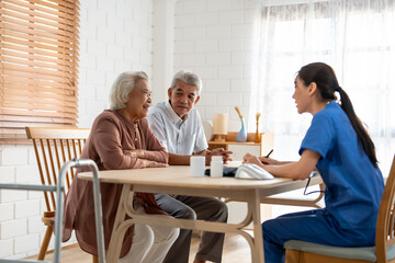 Asian caregiver nurse examine senior couple patient at home together. 