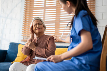 Asian caregiver nurse examine senior female patient with joint ache.