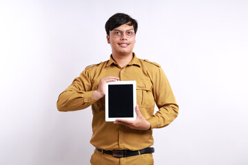 Smiling young Indonesian civil servant man professional company employee, showing digital tablet...