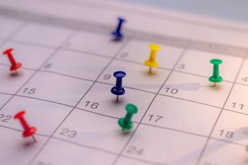 Colorful Push pin in calendar. Calendar page pinned in calender on date, business meeting schedule or travel planning concept. and reminder concept. Calendar appointment