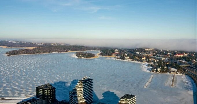 Timelapse of Sea fog moving over the Kulosaari island, sunny day in icy Helsinki