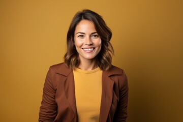 Obraz premium Portrait of a grinning woman in her 30s wearing a chic cardigan isolated on solid color backdrop
