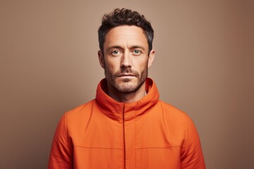 Fototapeta premium Portrait of a tender man in his 30s wearing a thermal fleece pullover while standing against solid color backdrop