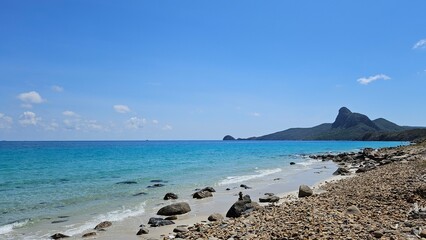 Beautiful beach at Con Son island, Vietnam, known as Con Dao island. Blue sky clouds, rock, sand, mountain and beach concept.