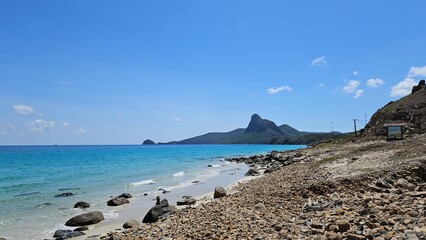 Obraz premium Beautiful beach at Con Son island, Vietnam, known as Con Dao island. Blue sky clouds, rock, sand, mountain and beach concept.