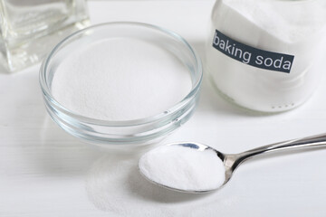 Baking soda on white wooden table, closeup