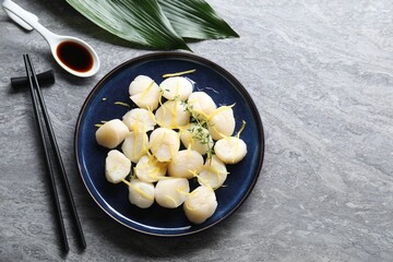Raw scallops with thyme and lemon zest served on grey marble table, flat lay. Space for text