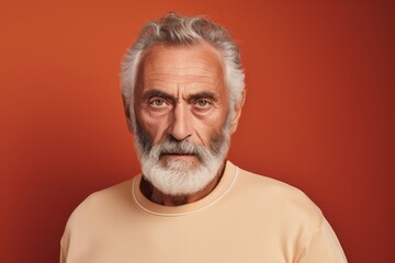 Obraz premium Portrait of a content man in his 70s sporting a long-sleeved thermal undershirt in front of solid color backdrop