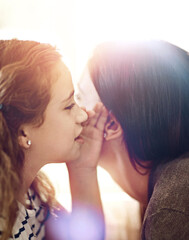 Fototapeta premium Gossip, secret or whisper with mother and daughter closeup in home together for security or trust. Children, family or news with girl child talking to single parent woman in apartment for safety