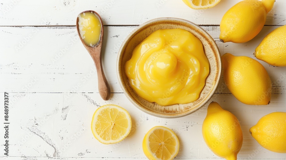 Wall mural tasty lemon curd served in a bowl on a white wooden table photographed from above - Wall murals