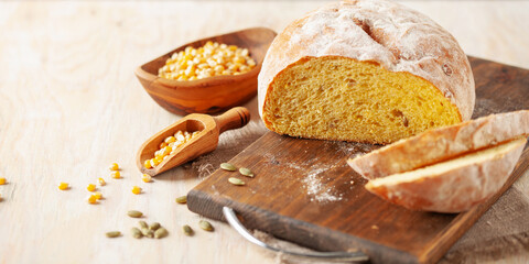 Fresh cornbread and corn grains on the table. Food grain crisis concept