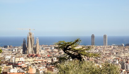 panoramic view of Barcelona with the Sagrada familiar and the Mediterranean sea
