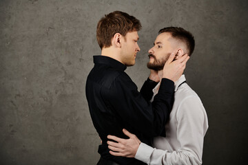 A gay couple in elegant suits, sharing an intimate gaze and a tender touch.