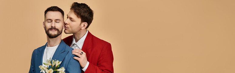 A loving gay couple in elegant suits, one whispering to the other.