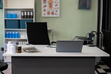 Top view of doctor desk table with stethoscope, coffee, Medical gown and notebook with pen.