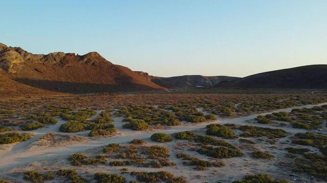 Golden hour over desert landscape in Mexico surround by hills in BCS Mexico