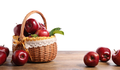 Fresh ripe red apples and green leaves on wooden table. Space for text