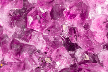 Amethyst pink crystals. Gems. Mineral crystals in the natural environment. Texture of precious and semiprecious stones. Seamless background with copy space colored shiny surface of precious stones.