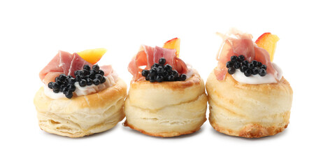 Delicious puff pastry with cream cheese, ham, black caviar and peach isolated on white