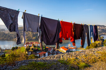 Cloths hanging on the washing line to dry in summer near the river Douro, Portugal