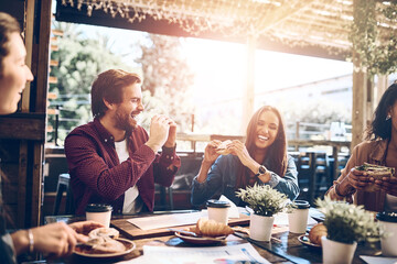Group of people, friends and lunch as colleagues for business, team building or meeting. Coworkers, positive and cheerful in restaurant for celebration or success in collaboration for company or job