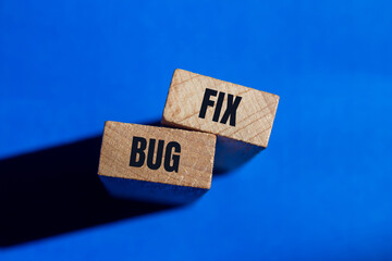 Bug fix message written on wooden blocks with blue background. Conceptual bug fix symbol. Copy space.