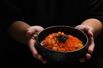 Stir fried spicy udon noodles with fresh salmon, tobiko egg and seaweed on top. Japanese fusion food concept