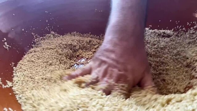 chef hand close up cous cous preparation in slow motion 