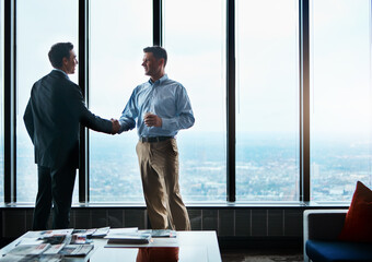 Office, business people and handshake for partnership, agreement or teamwork in corporate project....
