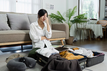 Woman Packing Suitcase for Travel in Modern Living Room, Preparing for Vacation, Organizing Clothes and Accessories, Stressful Moment, Home Interior with Cozy Furniture and Green Plants