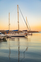 leisure yacht sailboats docked at small harbour in Cape Town at sunset