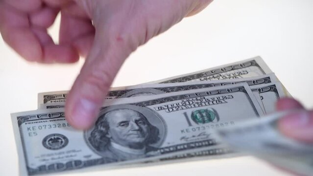 A rich man counts 1000 us dollars on a white background. Hands counting us dollar bills. man hands counting us dollar banknotes close up. 1000 dollars count. count money, count dollars, Money counting