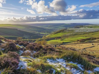 View from the top of Black Clover Mountain in Yorkshire, overlooking a green valley with some snow on heather and other flowers, a blue sky, late afternoon