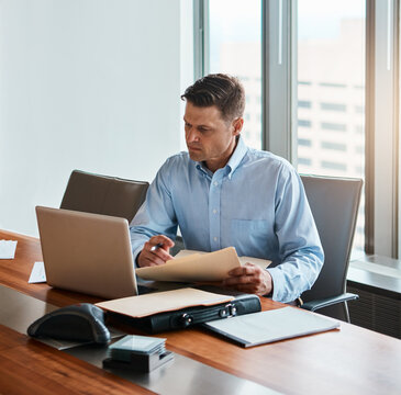 Office, laptop and businessman with document, contract and understanding information of case rules. Corporate firm, male lawyer and paperwork of compliance, regulations and approval before signature