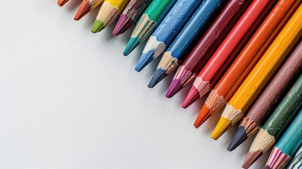 Fototapeta premium Colorful crayons in close up on a white backdrop