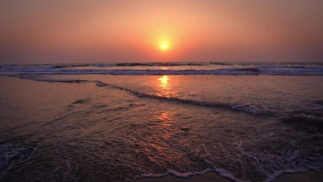 Wide angle shot of sunset at the Goa beach in India. View of the beach during the sunset. Summer Holidays at beach background. Beautiful sunset at beach