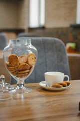 A cup of coffee with milk and sweet cookies