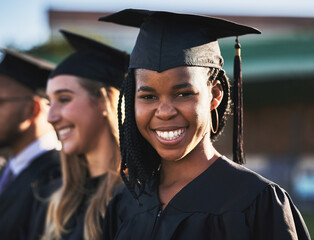 Happy black woman, students and graduation ceremony with class group for education, qualification or future. Portrait of person or scholar with smile for diploma, certificate or degree on campus