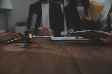 Judge gavel with Justice lawyers having team meeting at law firm background. Concepts of Law and Legal services.
