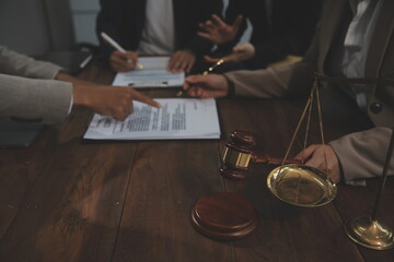 Judge gavel with Justice lawyers having team meeting at law firm background. Concepts of Law and Legal services.