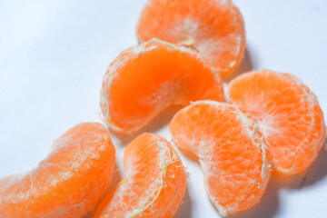 Isolated fresh peeled orange fruit colored orange and yellow. White background