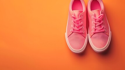 Pink tennis modern shoes isolated on orange background