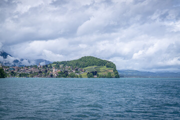 Obraz premium Schloss Spiez castle located on the top view of the city that we can see Thun lake and it has port cruising between Thun and Interlaken of Thun lake